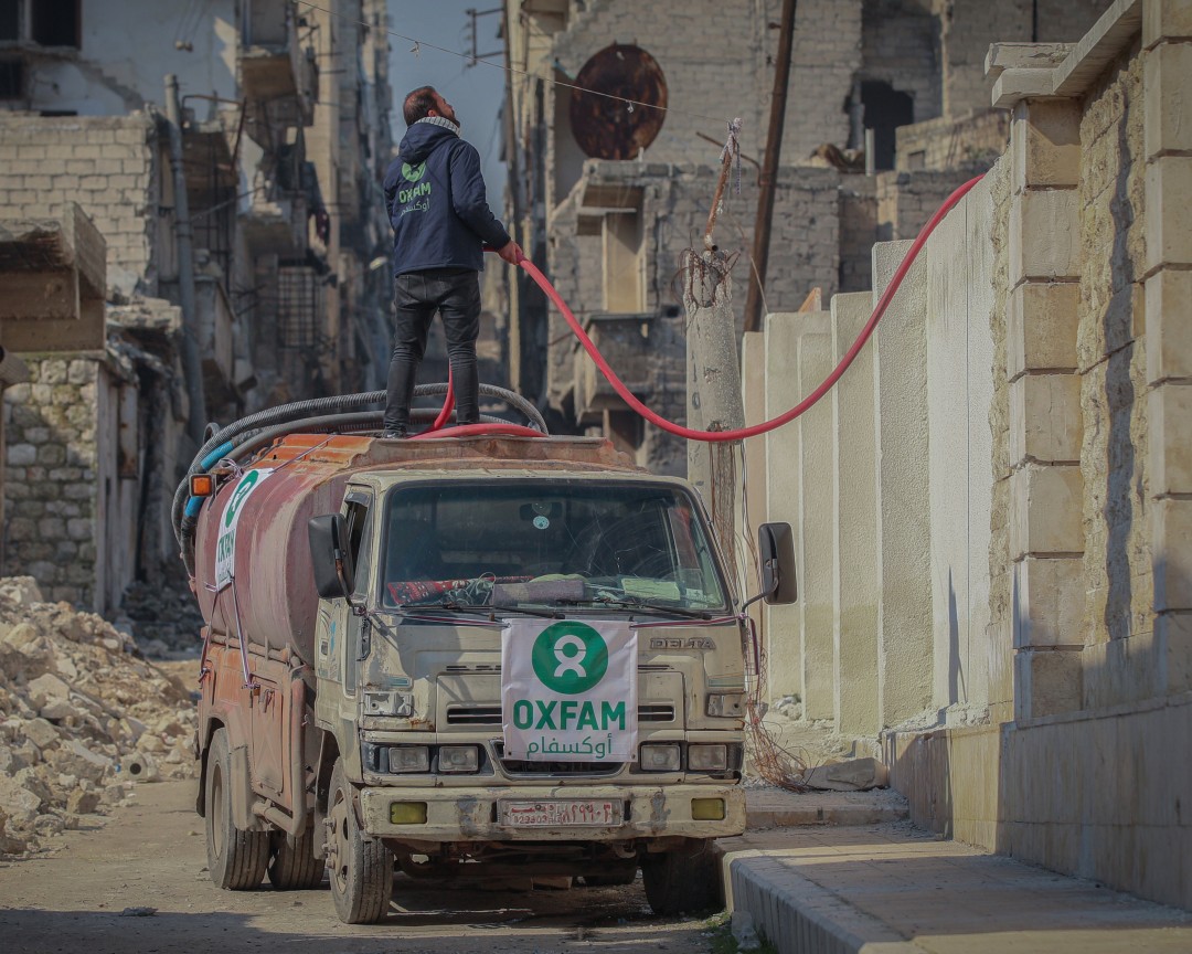 Oxfam is shown in the pictures delivering water to shelters in Aleppo city.